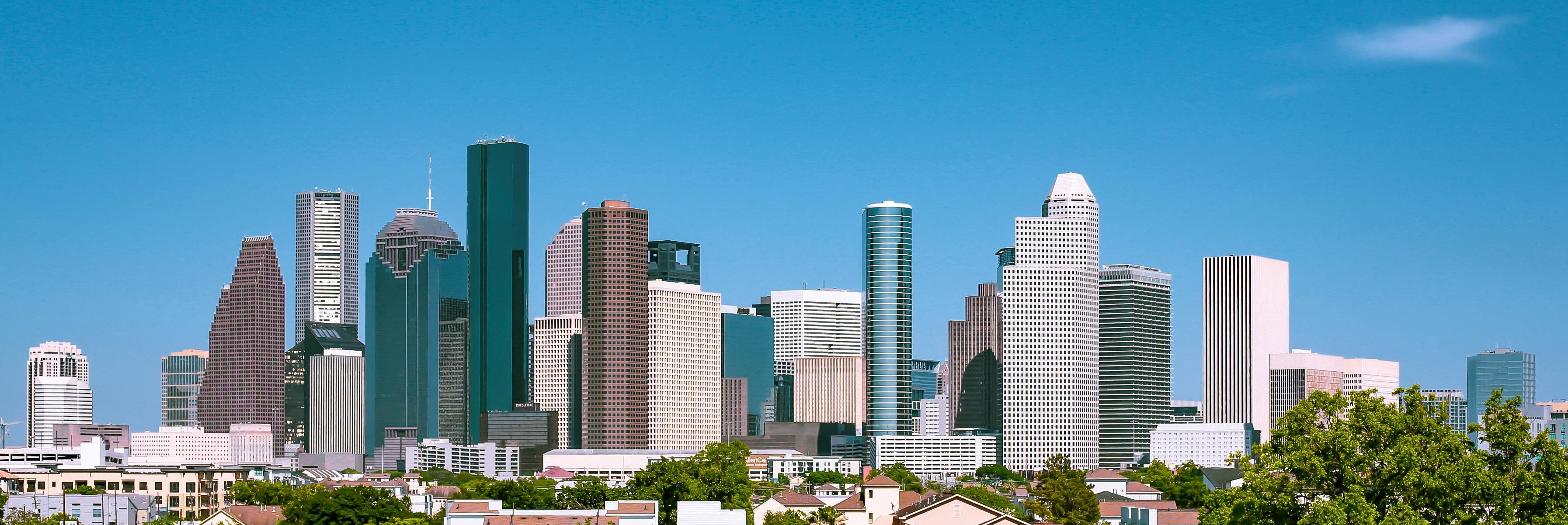 Houston skyline with lit downtown buildings at dusk